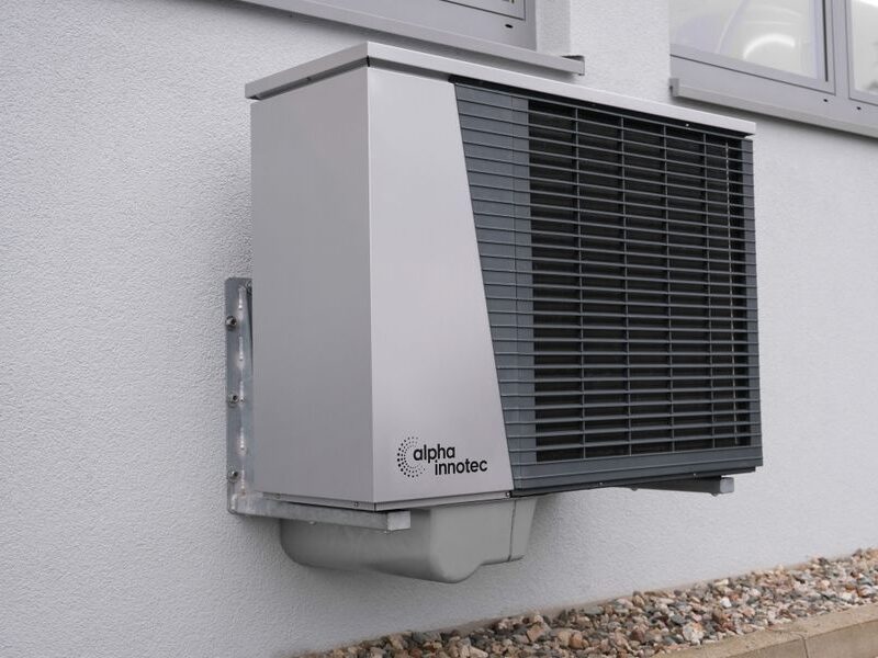 Modern outdoor heat pump unit installed on a home exterior